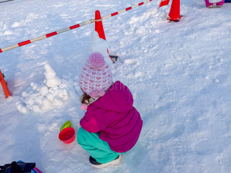 a child playing with snow at tsudome site of sapporo snow festival