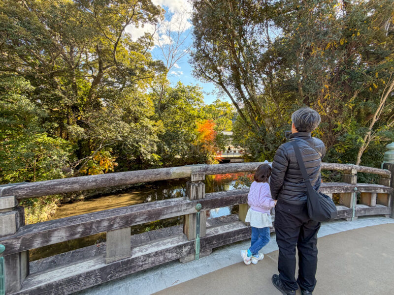 a child and their father crossing a bridge at Ise Jingu