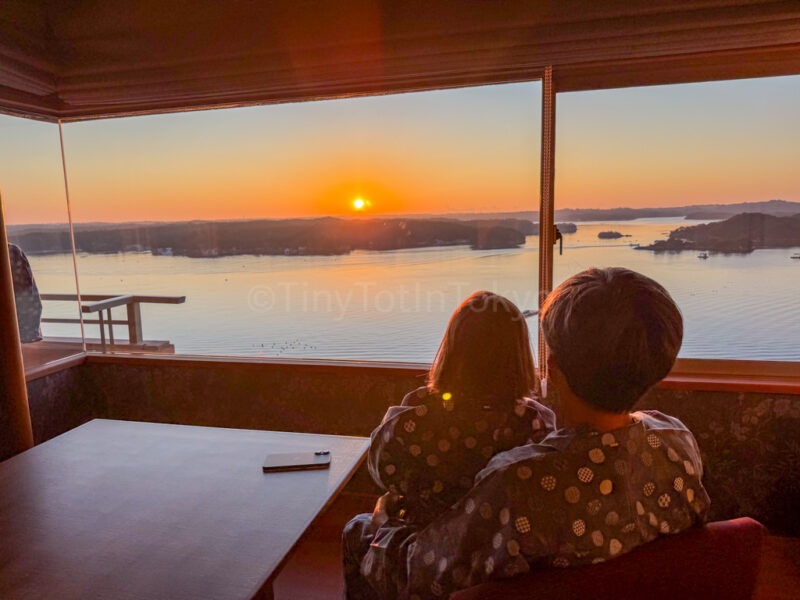 a parent and child looking at the sunrise. from their room at Kashikojima Hojoen ryokan