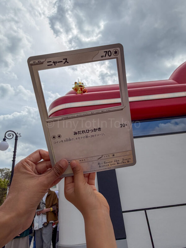 a parent and child doing the pokemon card activity at pokepark kanto