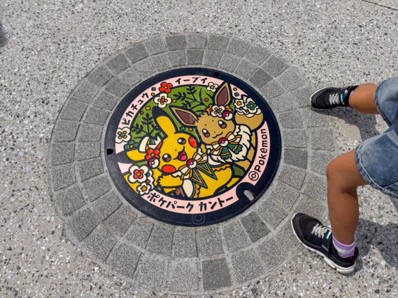 pikachu and eevee manhole cover at pokepark kanto