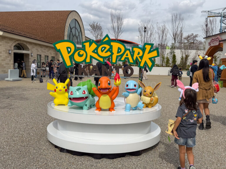 A child standing in front of the PokePark Kanto sign