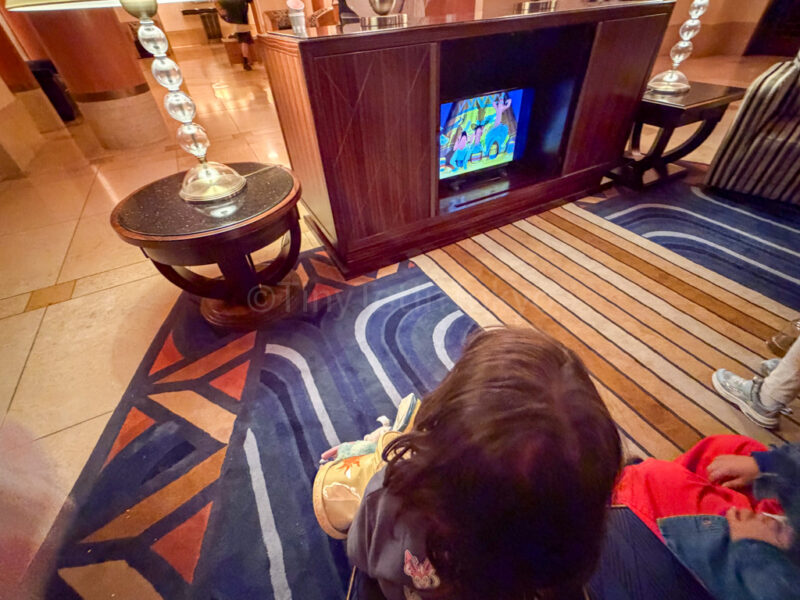 a child watching a disney movie at tokyo disney ambassador hotel
