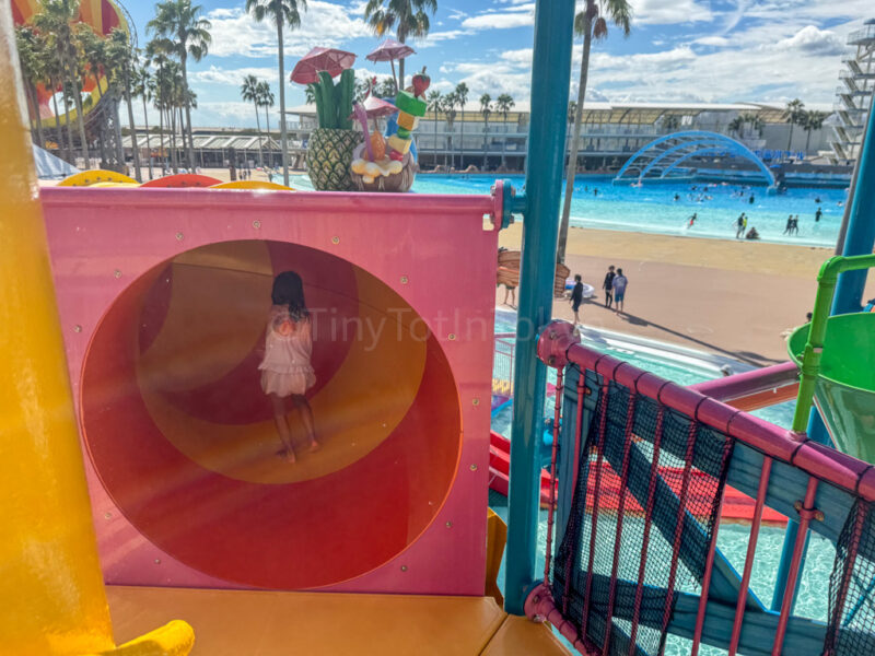 a child going through a tunnel in the kids area at Nagashima Water Park Jumbo Saltwater Pool
