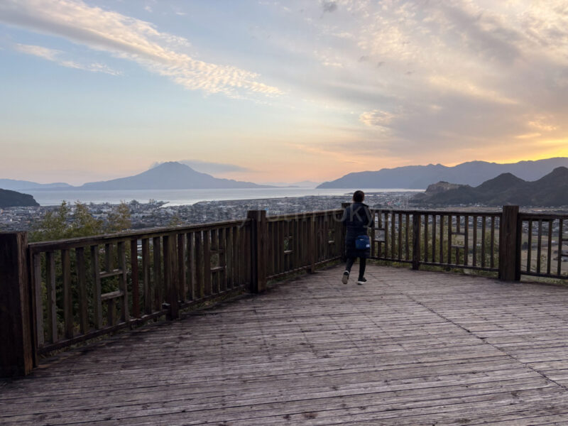 the author watching the sunset and sakurajima from observation deck in kagoshima