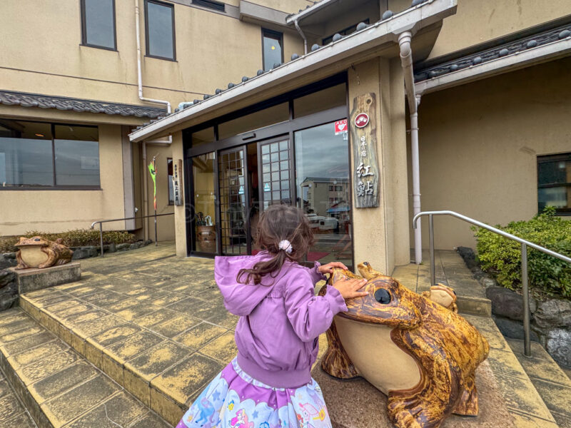 a child in front of ryokan beniayu in shiga
