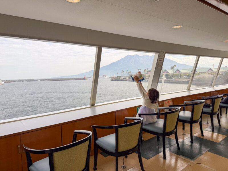 a child on the ferry for sakurajima