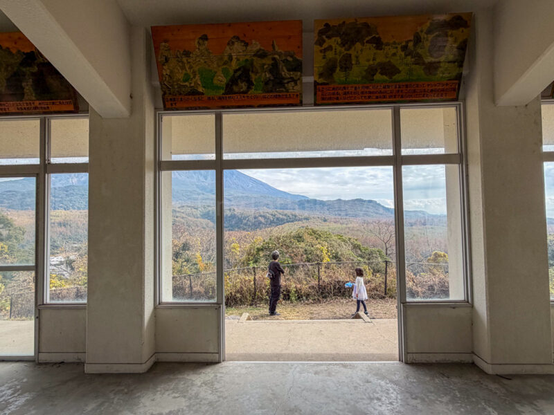 a parent and child inside the observation deck at Sakurajima Natural Dinosaur Park.