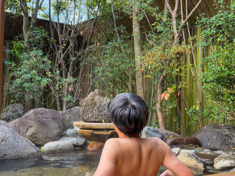 a man relaxing in an private onsen bath at Shikinoyado Meisui ryokan in Kagoshima