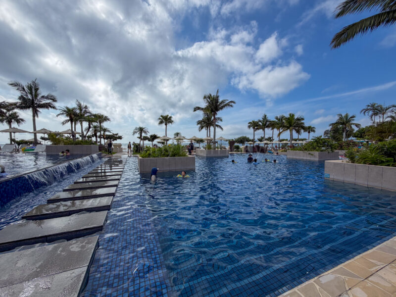 people swimming in pool at fusaki beach resort ishigaki