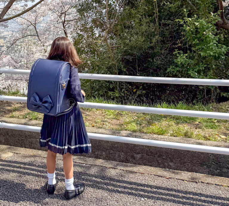 an elementary school student in japan wearing a backpack called randoseru