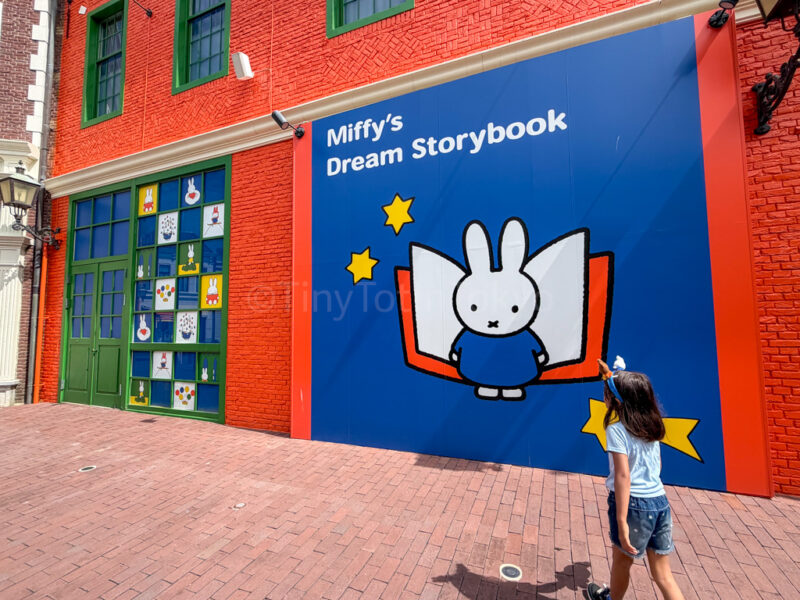 a child walking in front of Miffy's dream storybook