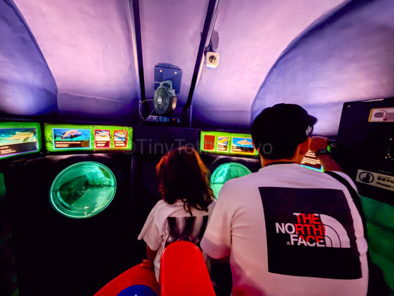 a parent and child inside the submarine adventure ride at legoland japan