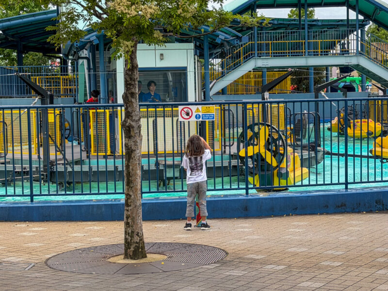 child pressing water bomb button at legoland japan 