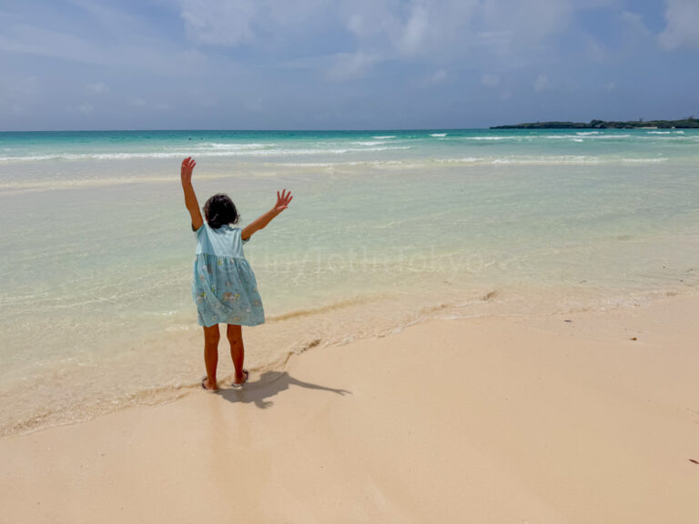 a child standing on toguchi beach in Miyakojima