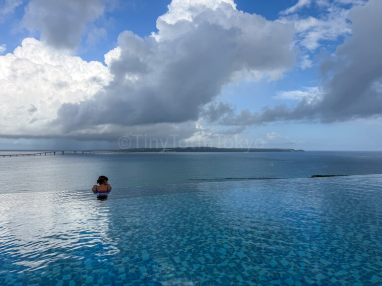 the author looking out from the rooftop pool at canopy by hilton in okinawa miyako island