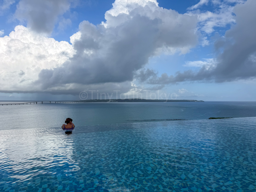 the author looking out from the rooftop pool at canopy by hilton in okinawa miyako island