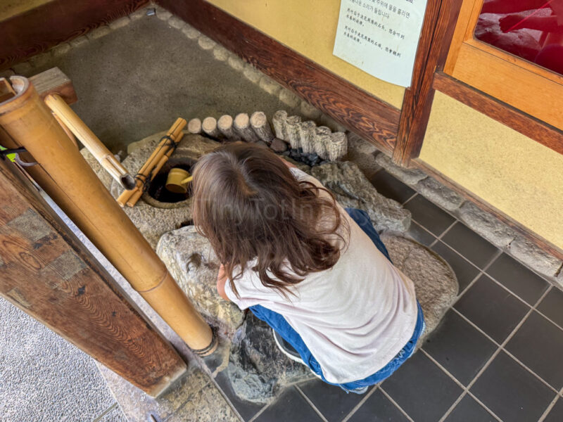 child with tsukubai at nagoya castle