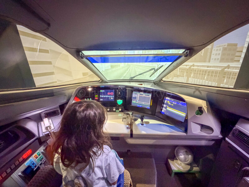 a child being a shinkansen driver at SCMAGLEV and Railway Park