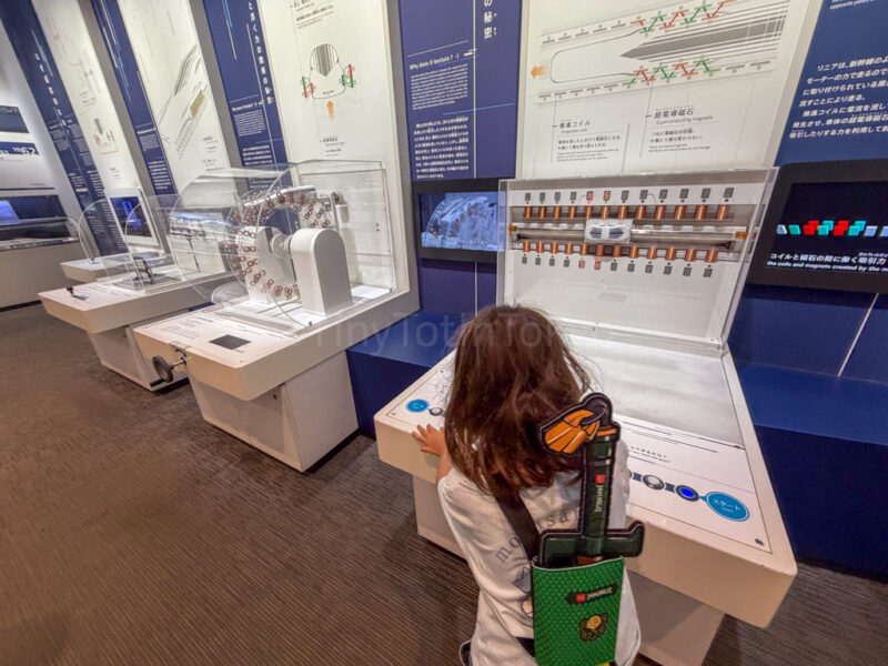 a child looking at a display at SCMAGLEV and Railway Park